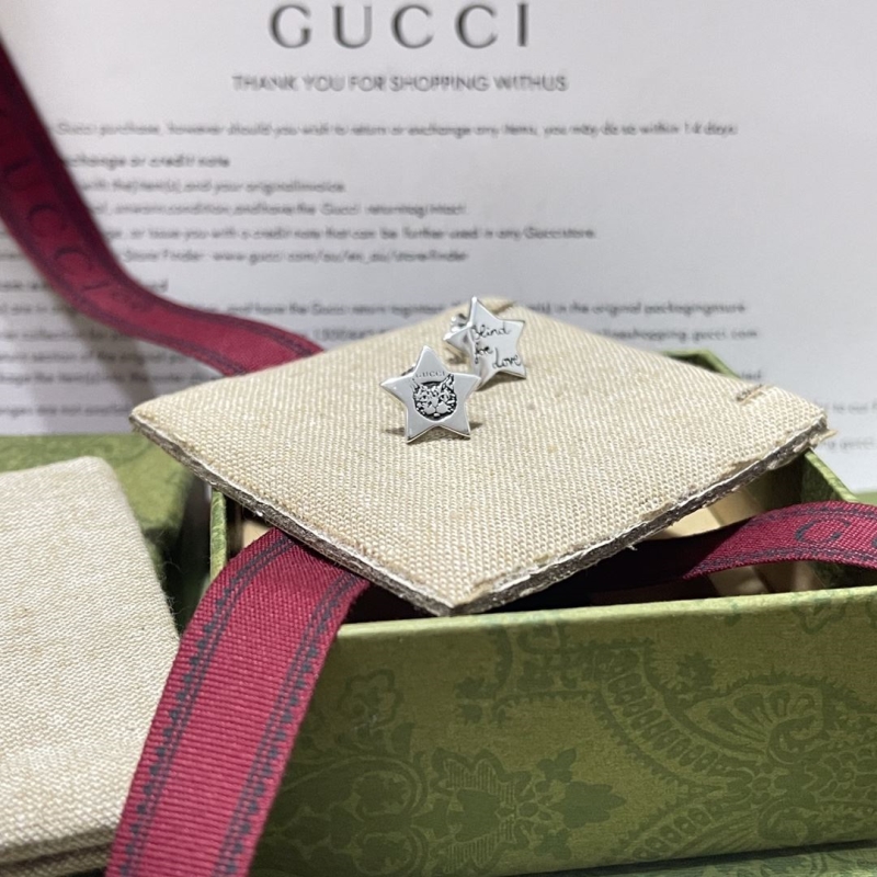 G*u*i earrings